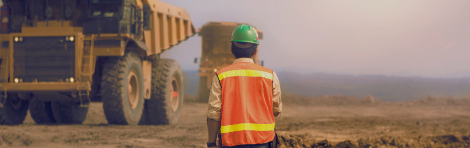 Mining worker looking at a mining truck 