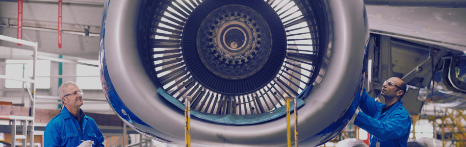 two aerospace engineers working on a plane engine