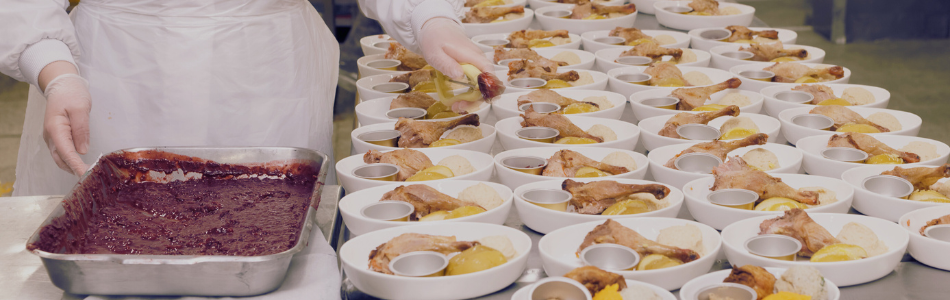 Person with with gloves handling food on scale