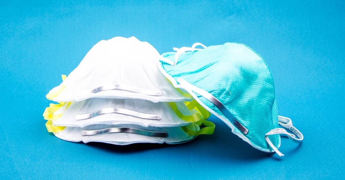 stack of face masks with blue background